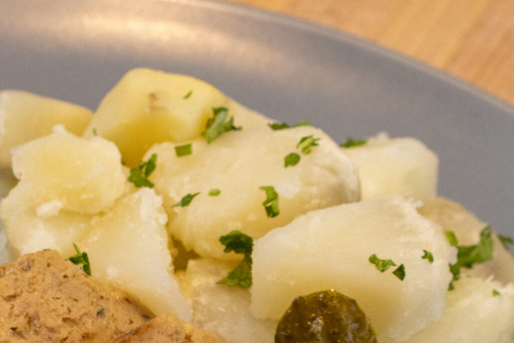 Detail on Boiled potatoes with butter on the plate. Side close up shot