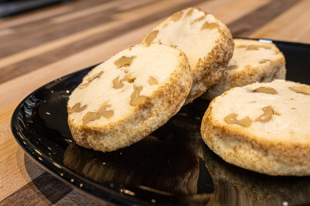 Masaryk's Cookies (Masarykovo cukroví) on black plate, medium distance detail with a little bit of visual countertop
