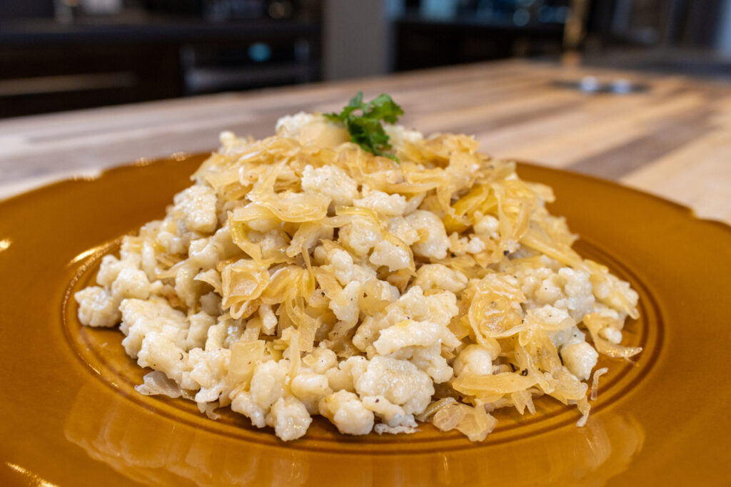 Halušky with Sauerkraut in detail side shot on the golden plate