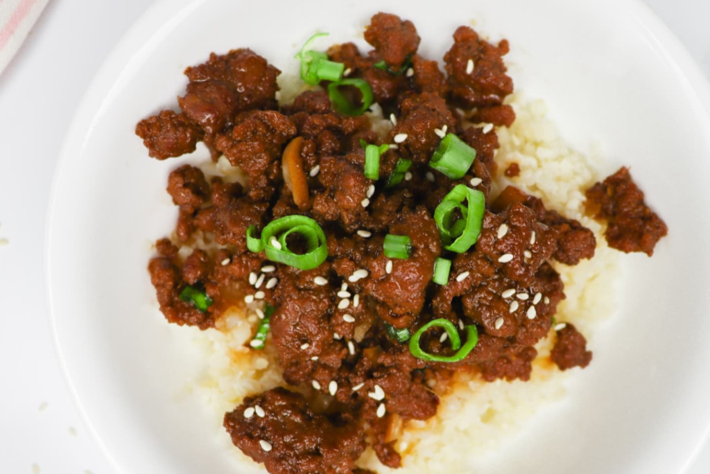 Easy Keto Korean Beef With Riced Cauliflower on the white plate, top view