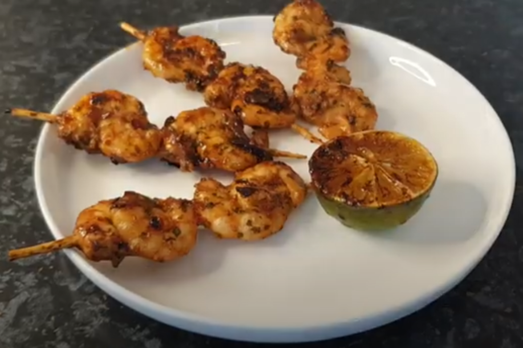 Prawn Kushiyaki on the white plate, top view, plate is on the black surface