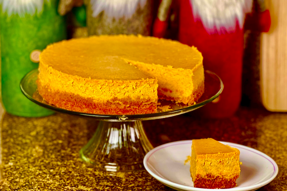 Spiced Sweet Potato Cheesecake on the cake platter with its slice in front of it
