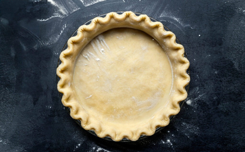 pie crust on the dark surface, top view