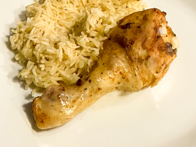Creamy Garlic Butter Baked Chicken and Herb Rice on the plate in top detail shot
