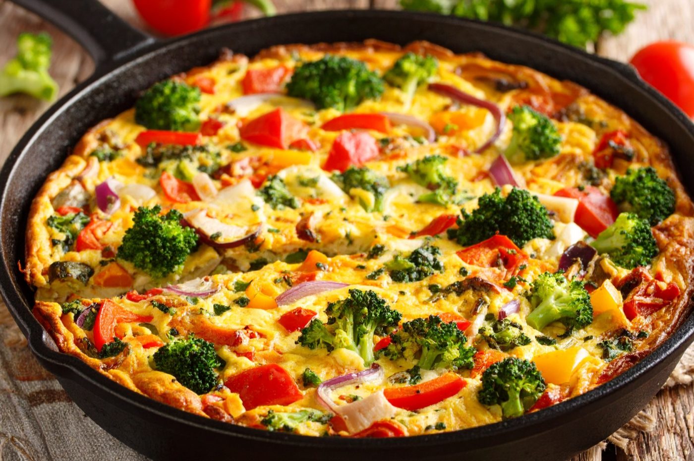 A colorful frittata in a cast-iron skillet