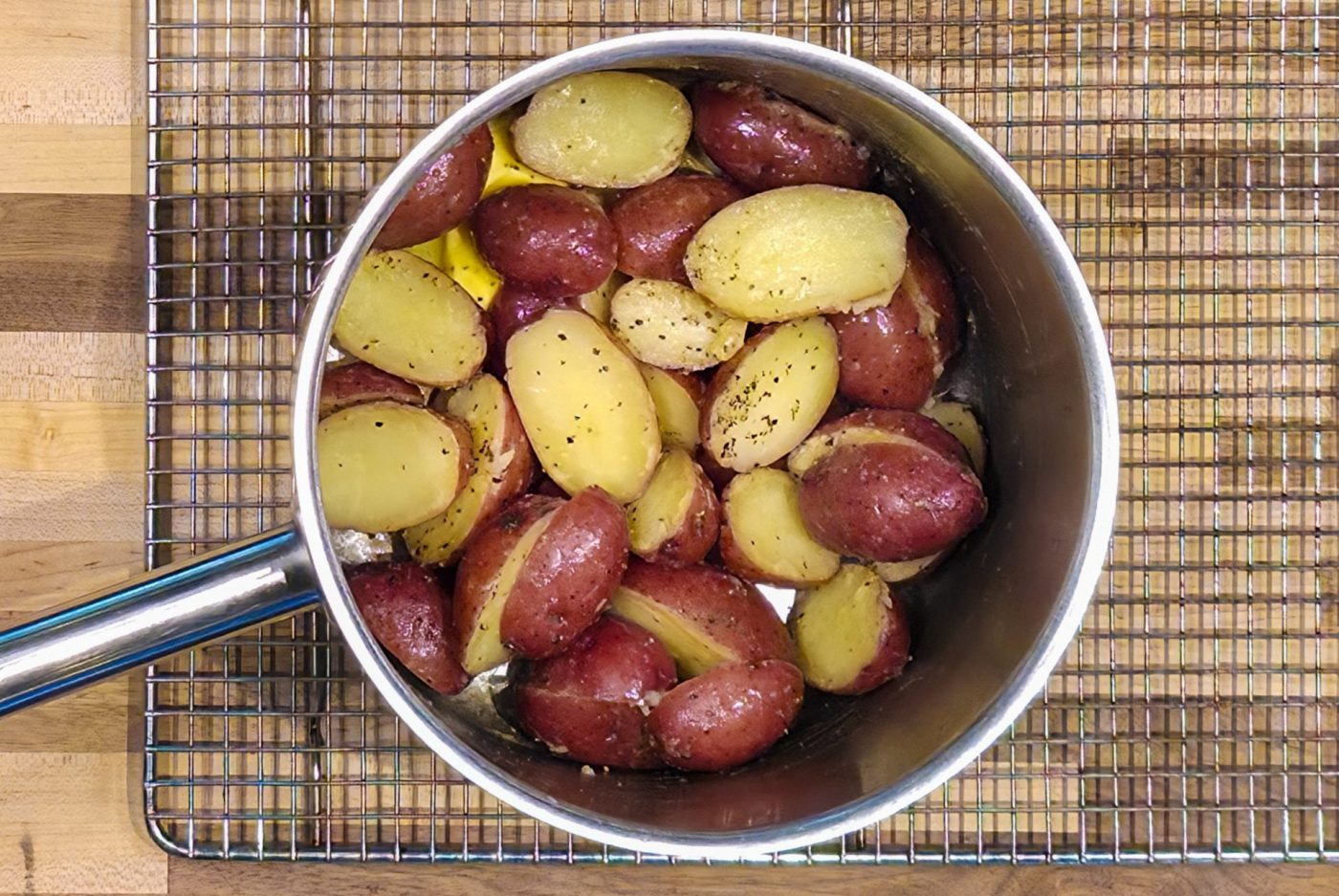 A top-down, close-up view of freshly prepared Baby Red Potatoes with Butter in a pot.