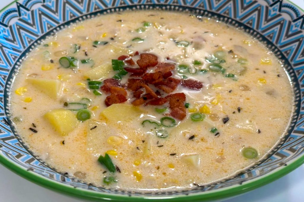 Corn and Potato Chowder served in the decorative blue and white plate, top side close up detail shot.