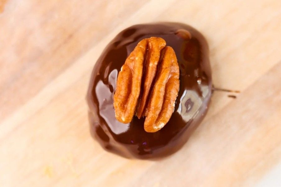 top shot of one Keto Pecan Pie Truffles on the countertop