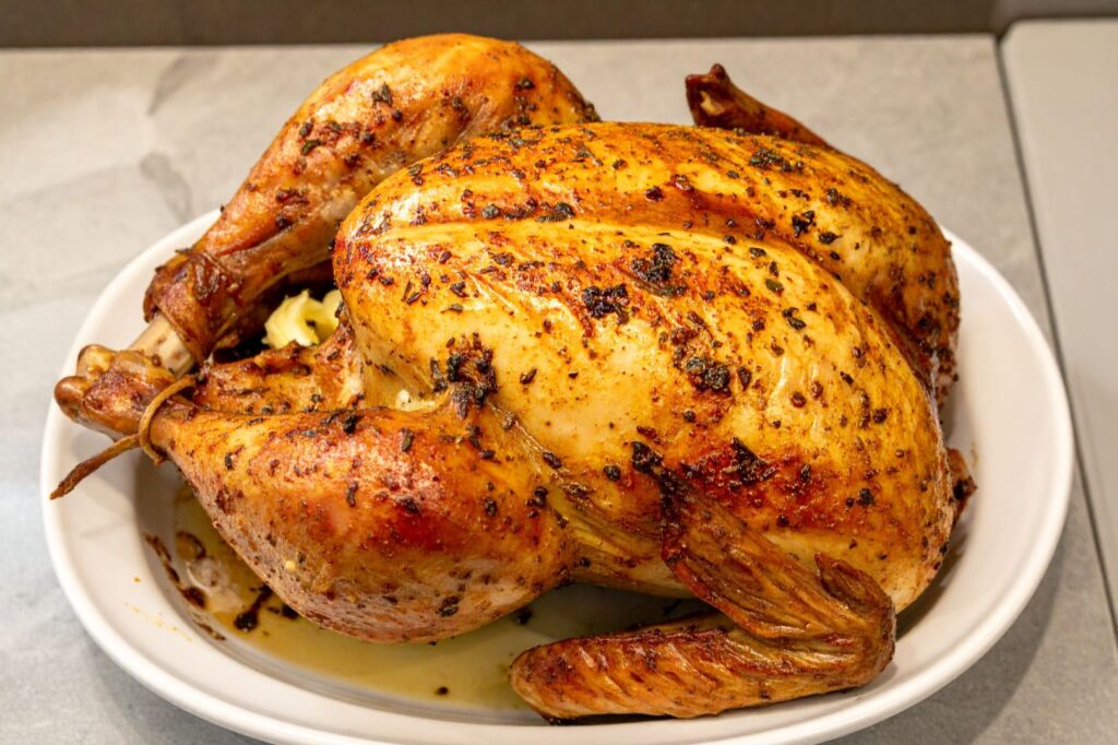 Recipe image Classic Roasted Chicken on the serving platter ready to be served, close up side shot