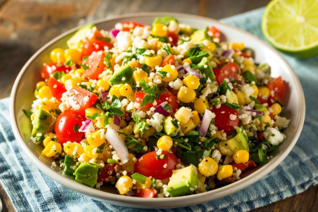 Summer Corn Salad in the bowl on the kitchen towel, close up shot.
