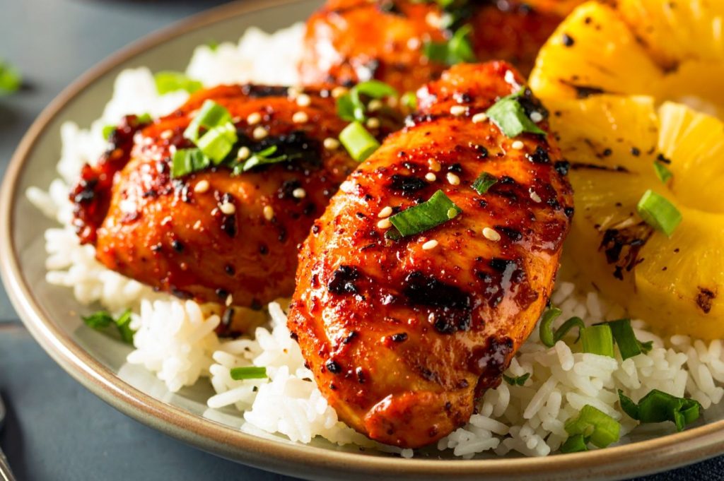 Huli Huli Chicken in detail on the plate with rise, close up side shot