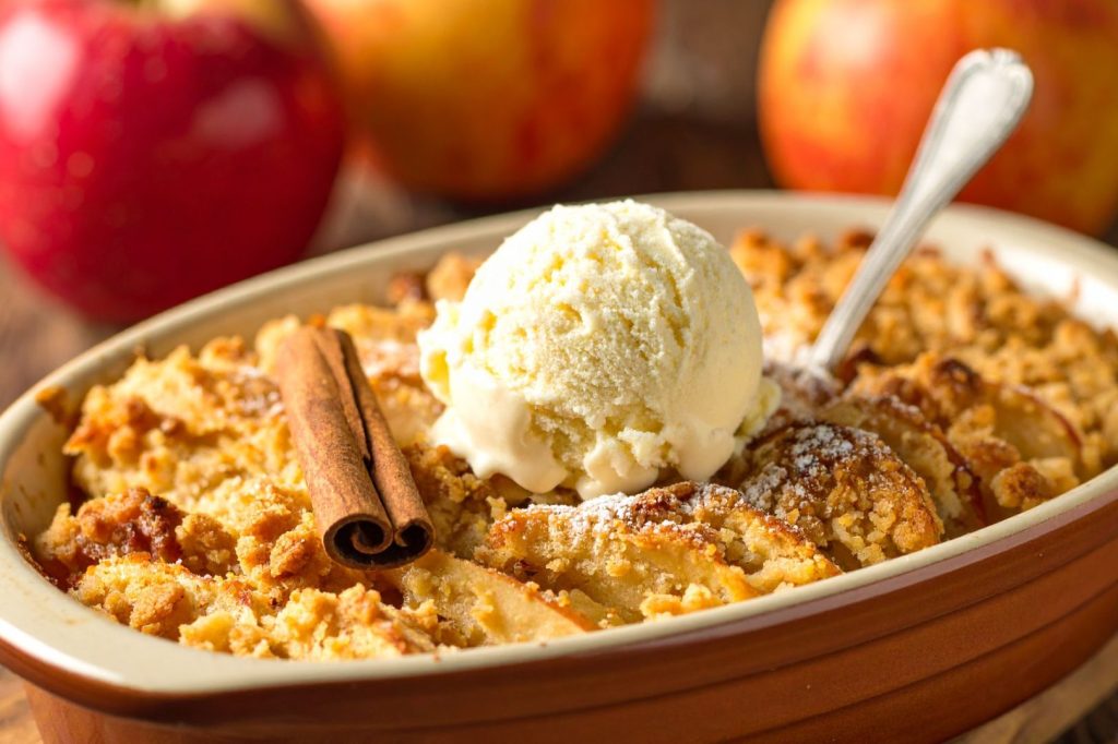 Apple Crisp in the baking dish with a scoop of ice cream on the top, detail side shot