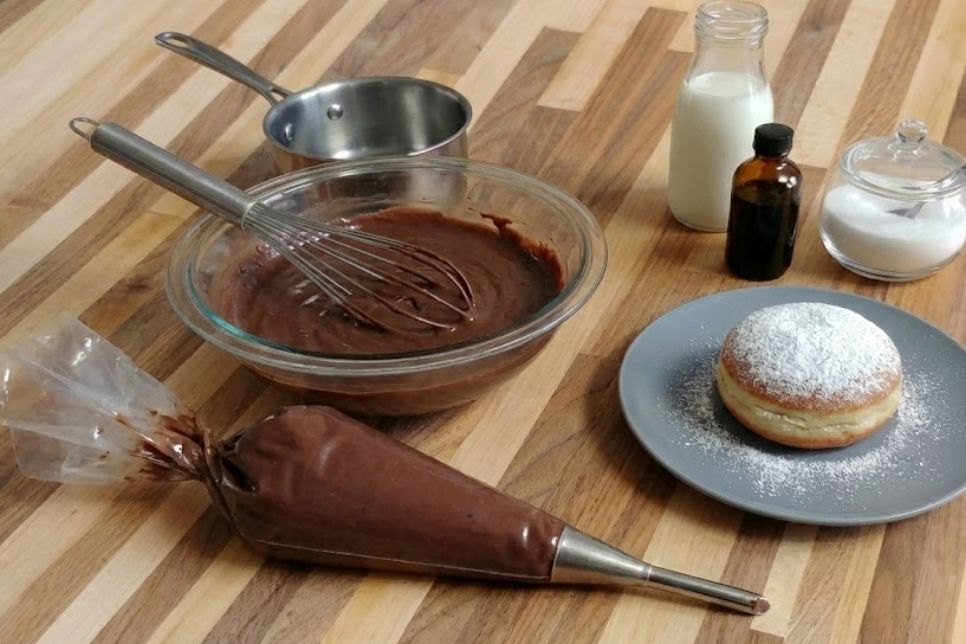 Recipe image Chocolate Pastry Cream for Filling Pastry in the pastry bag and also in the mixing bowl ready to fill czech doughnut