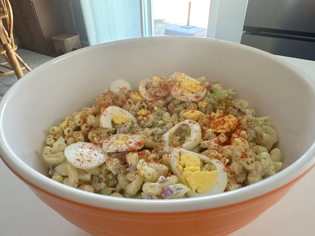 Deviled Egg Pasta Salad served in the small mixing bowl, side close up shot